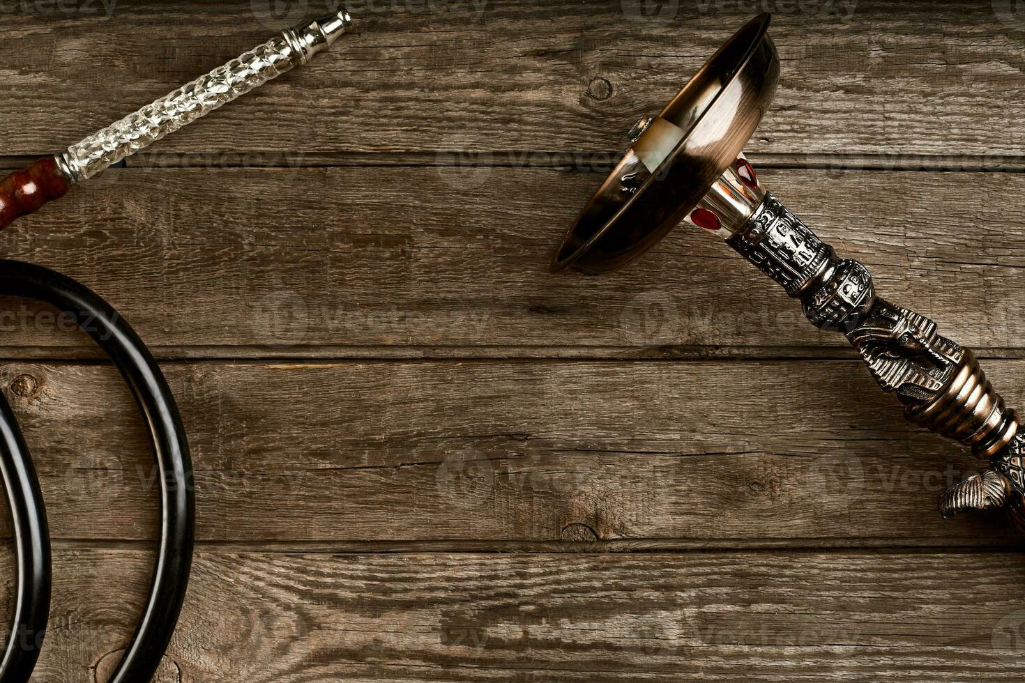 Dismantled parts of hookah on wooden background. photo