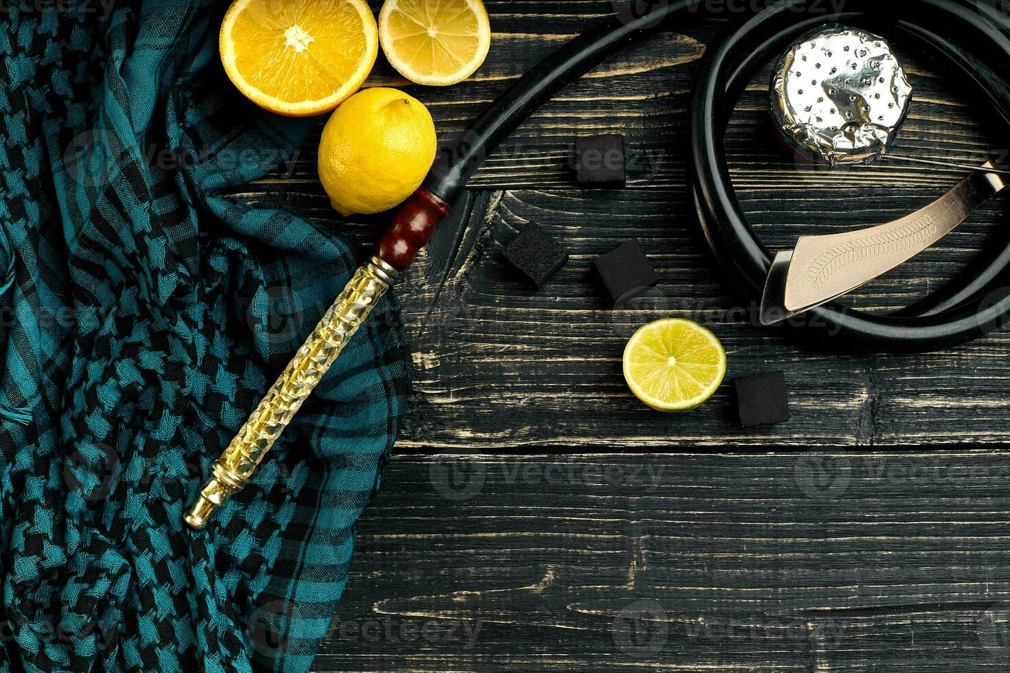 Top view of Hookah with orange fruit on a wooden background photo