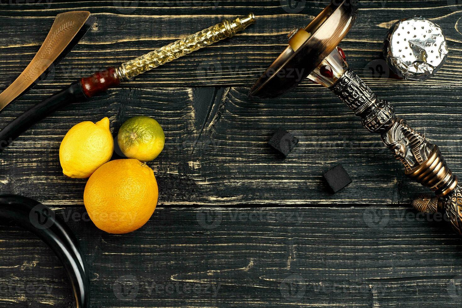 Dismantled parts of hookah on a wooden background with lime frui photo