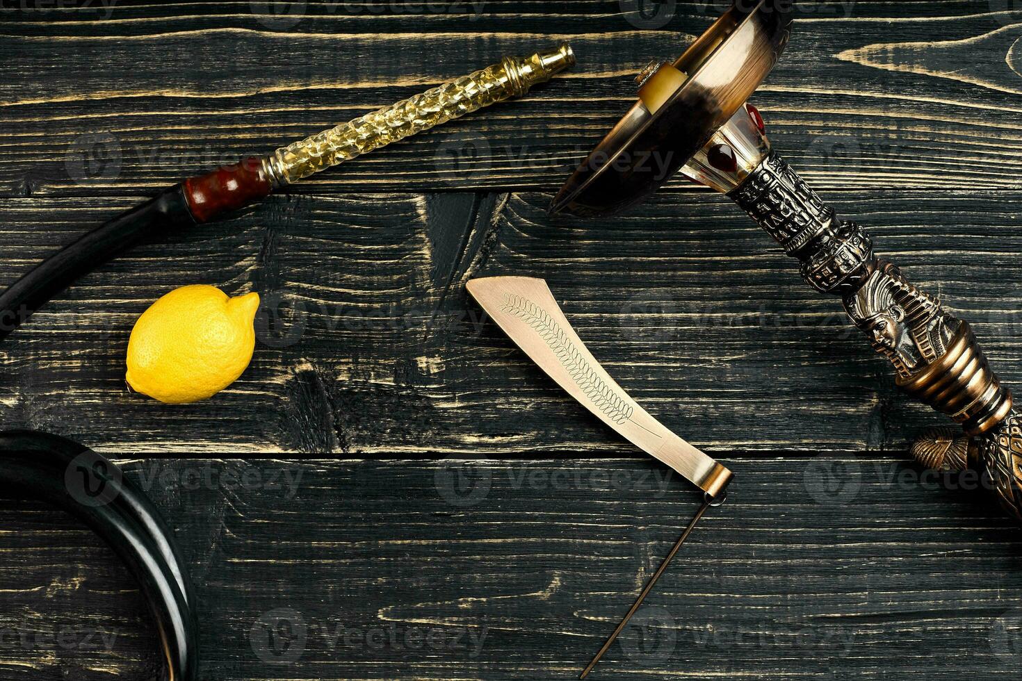 Dismantled parts of hookah on a wooden background with lemon fru photo