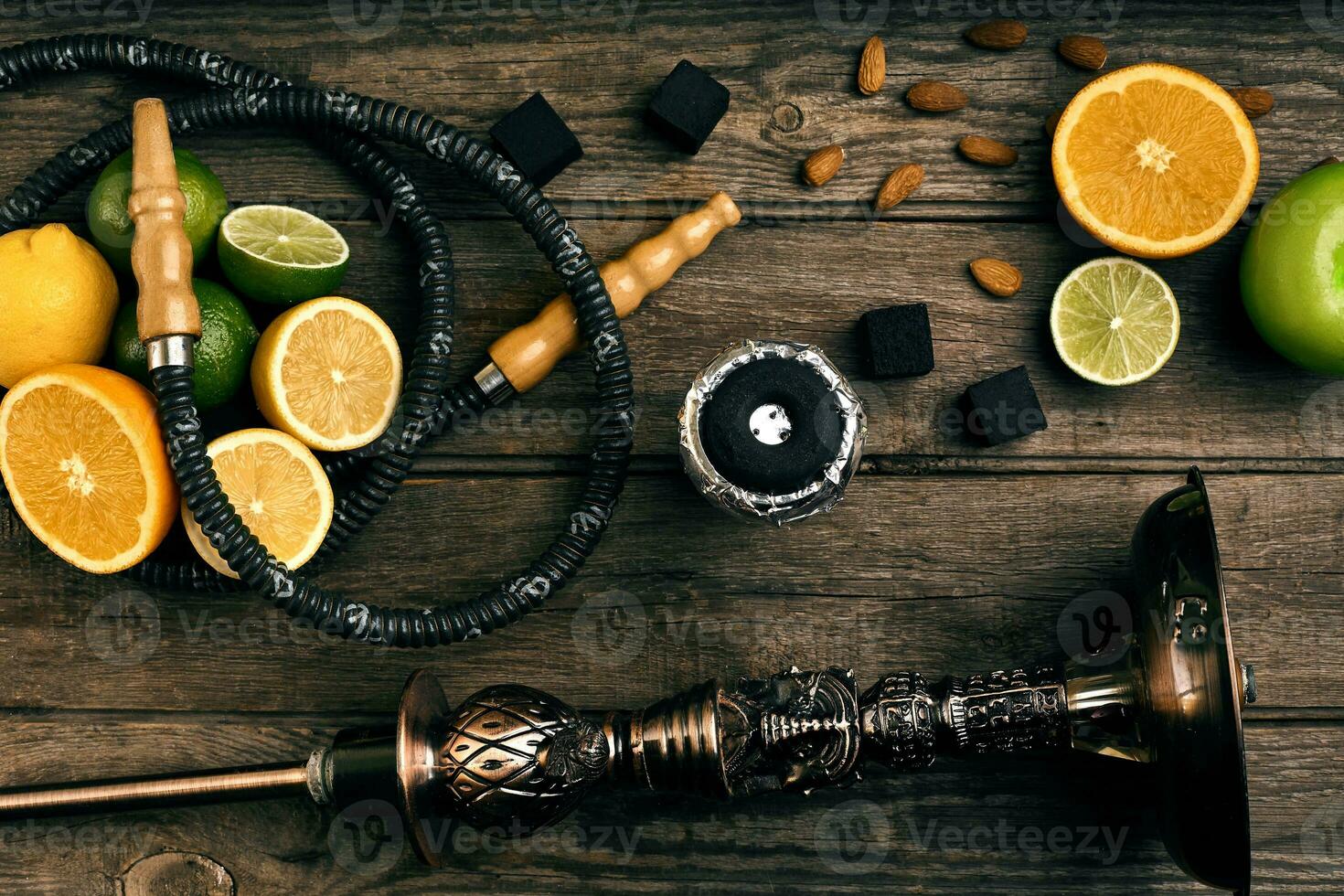 Stylish Smoking hookah and basket with lemon, lime and orange on photo