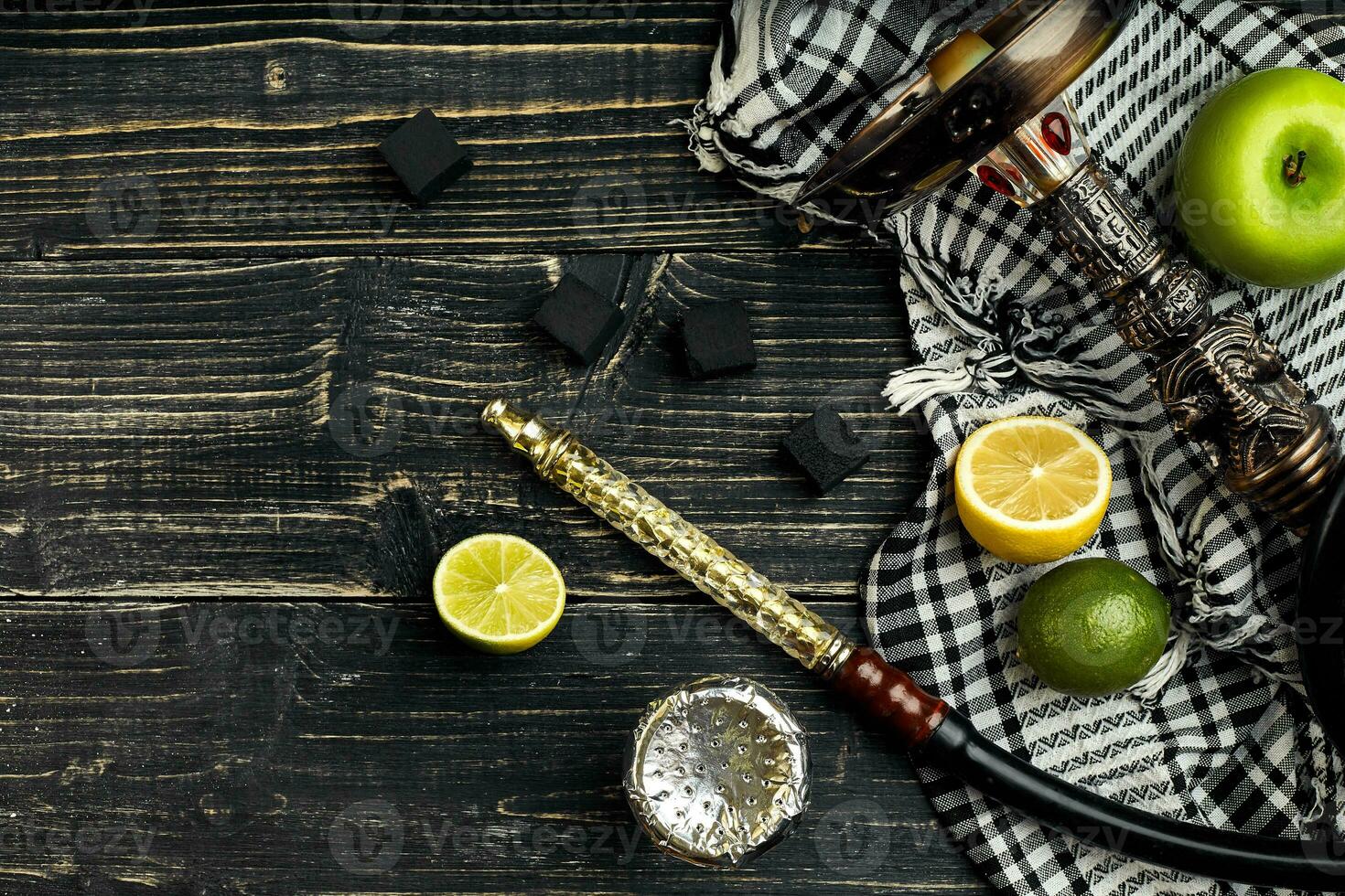Arabic hookah with a tobacco flavor of a mixture of citruses and apple photo