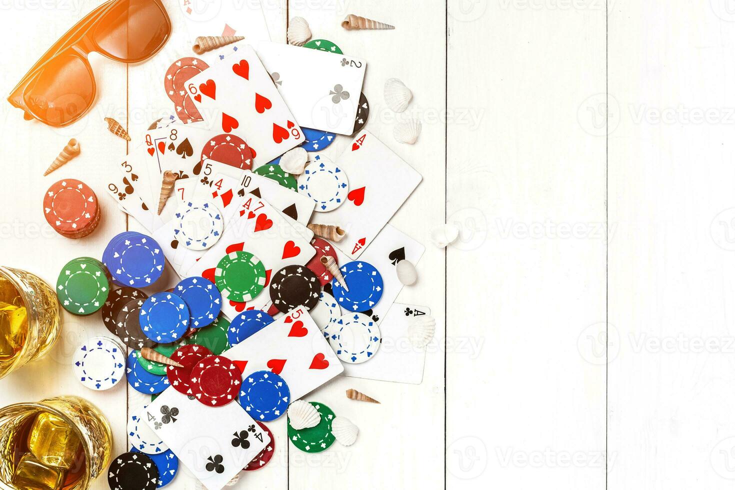 Gambling. Poker chips, cards, sunglasses and flip-flops on wooden table. Top view. Copyspace. Poker photo