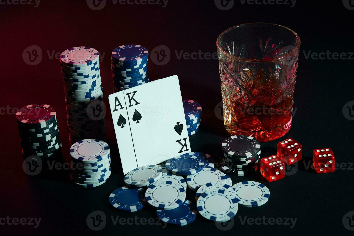 Cards of poker player. On the table are chips and a glass of cocktail with whiskey. Cards - Ace and King photo