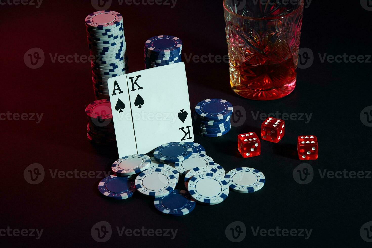 Cards of poker player. On the table are chips and a glass of cocktail with whiskey. Cards - Ace and King photo