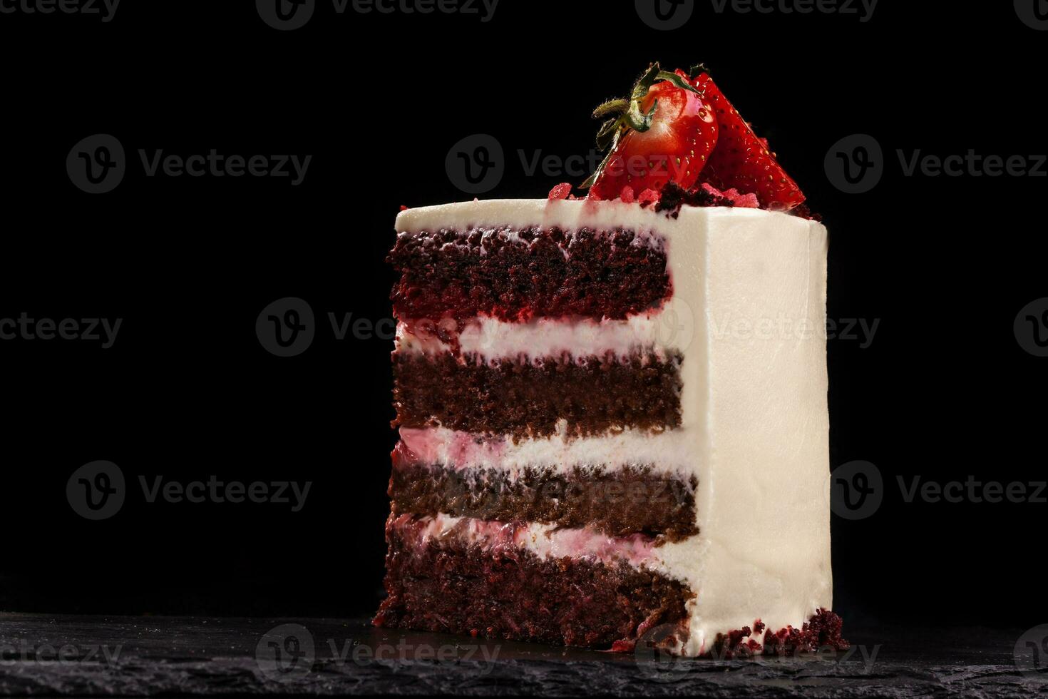 Piece of strawberry cake on a black background. photo