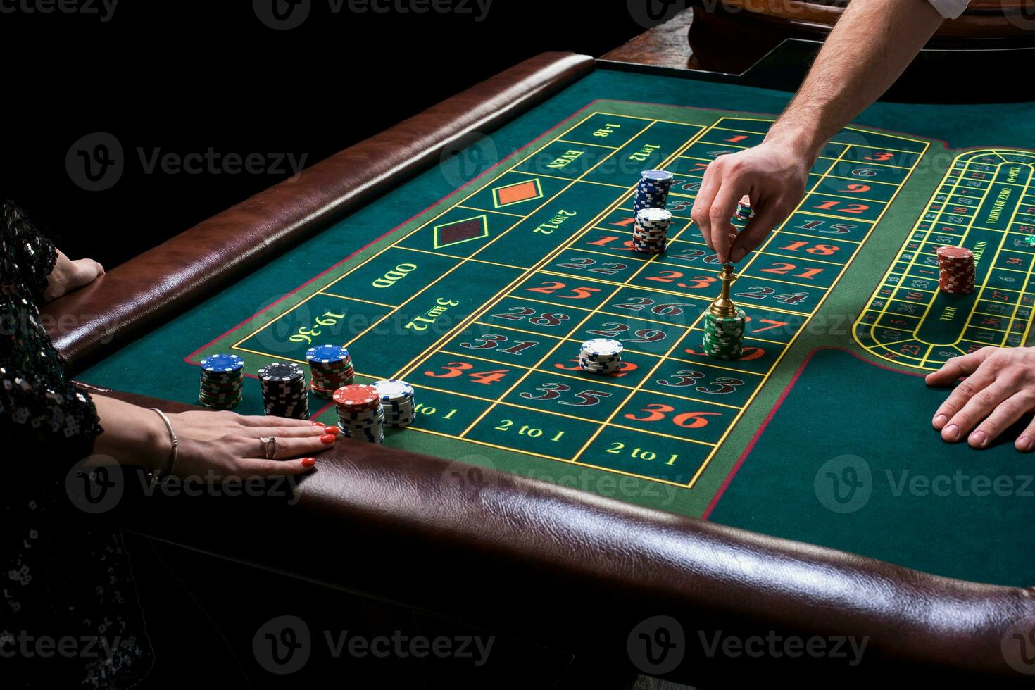 Croupier behind gambling table in a casino. photo