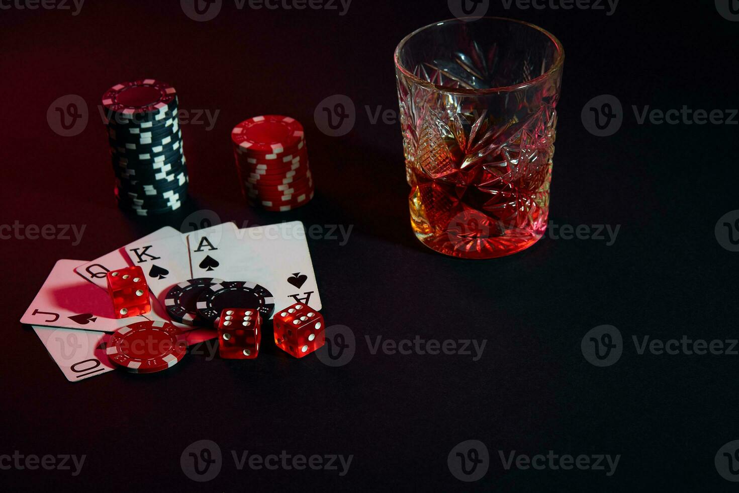 Cards of poker player. On the table are chips and a glass of cocktail with whiskey. Combination of cards - Royal Flush photo