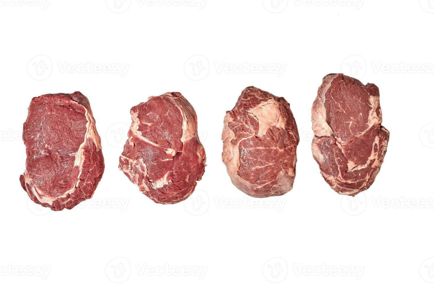Four pieces of fresh raw beef steaks isolated on white background, top view. photo