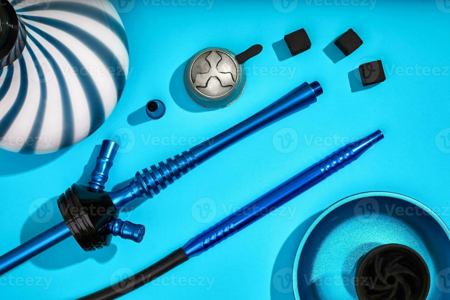 Parts of blue decorated hookah or shisha on light blue backgroun photo