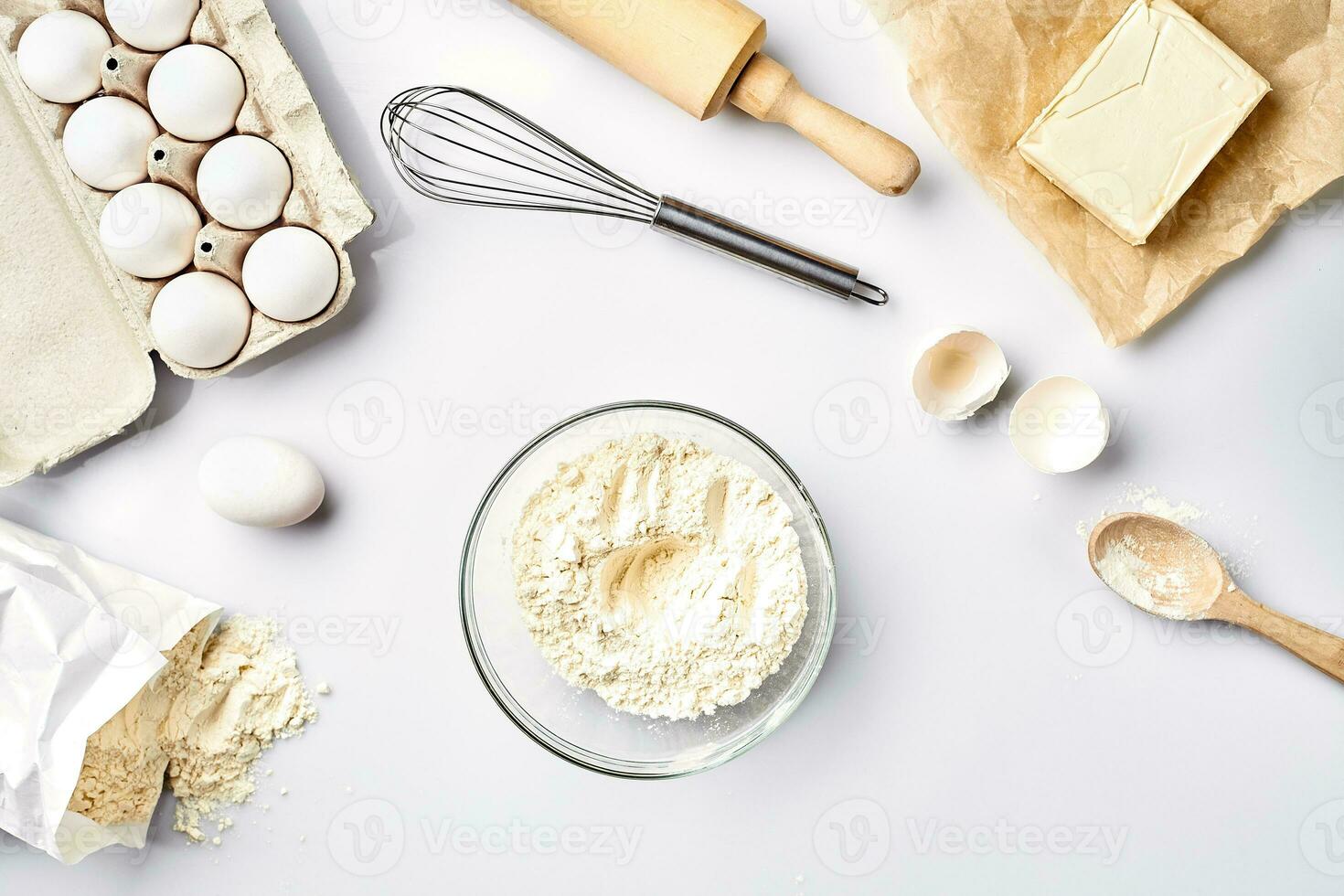 Baking ingredients for pastry on the white table photo