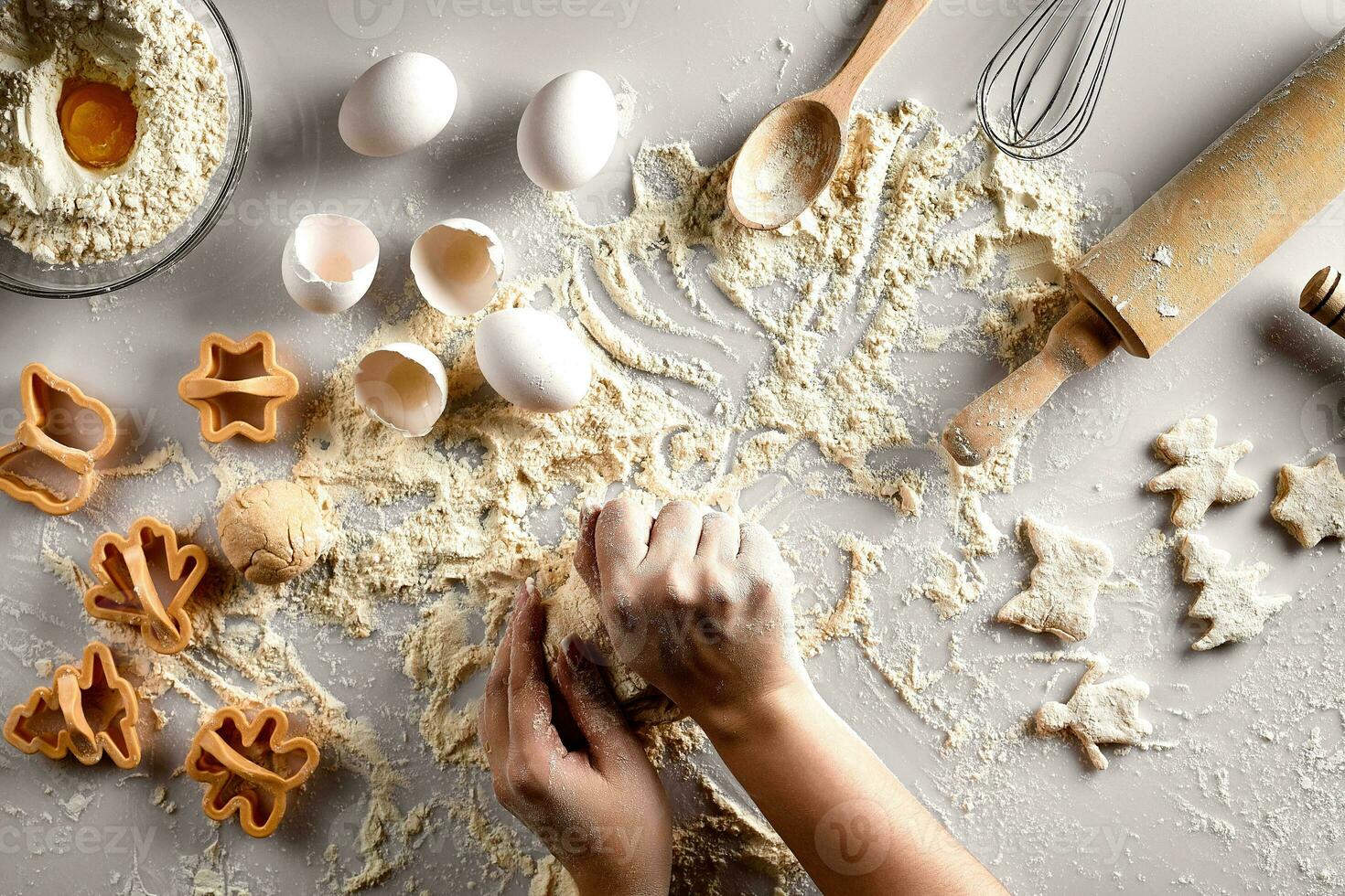 Baking preparation. Raw dough and cutters for the holiday cookies on a white table. Top view. photo