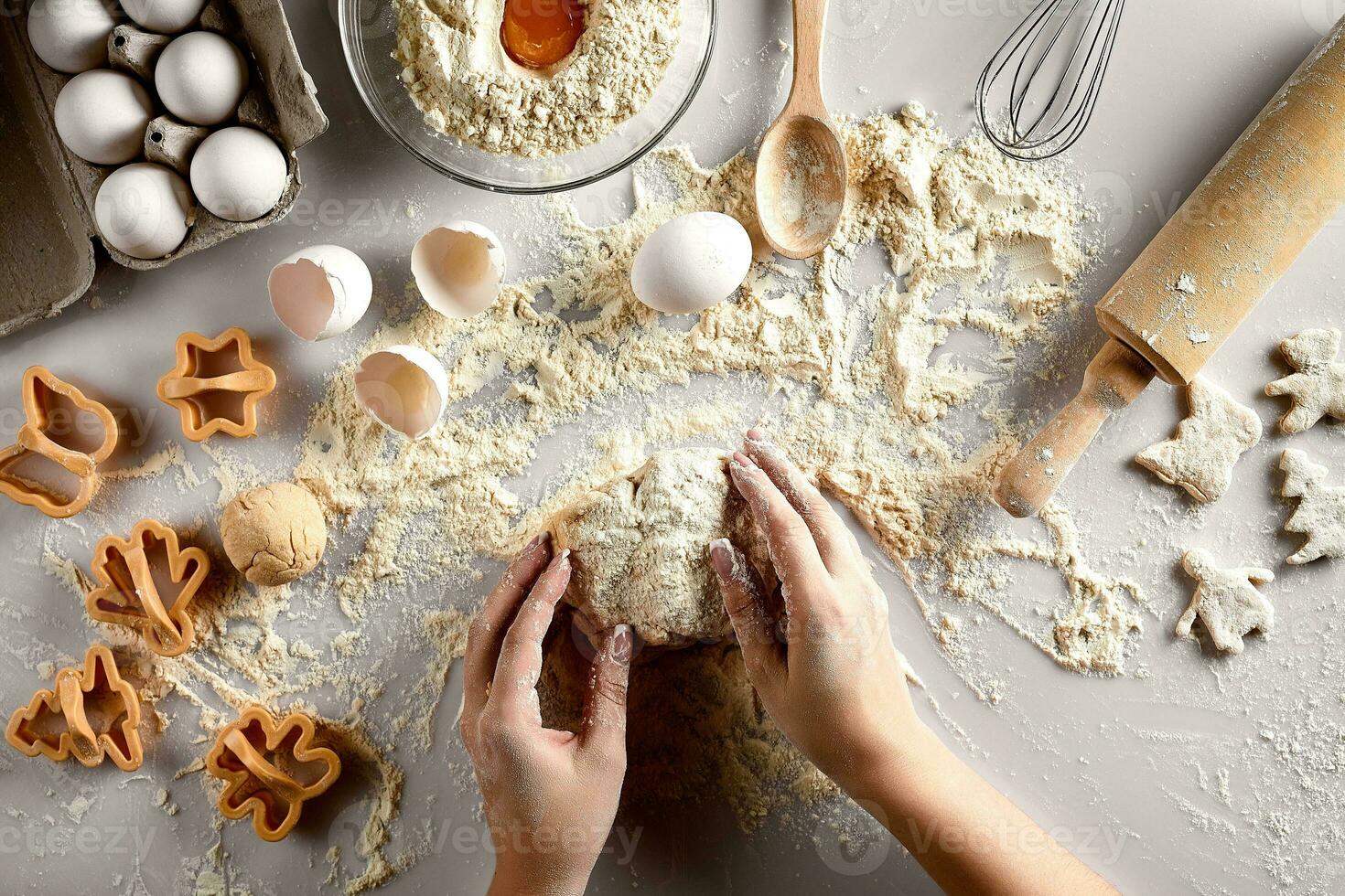 Baking preparation. Raw dough and cutters for the holiday cookies on a white table. Top view. photo