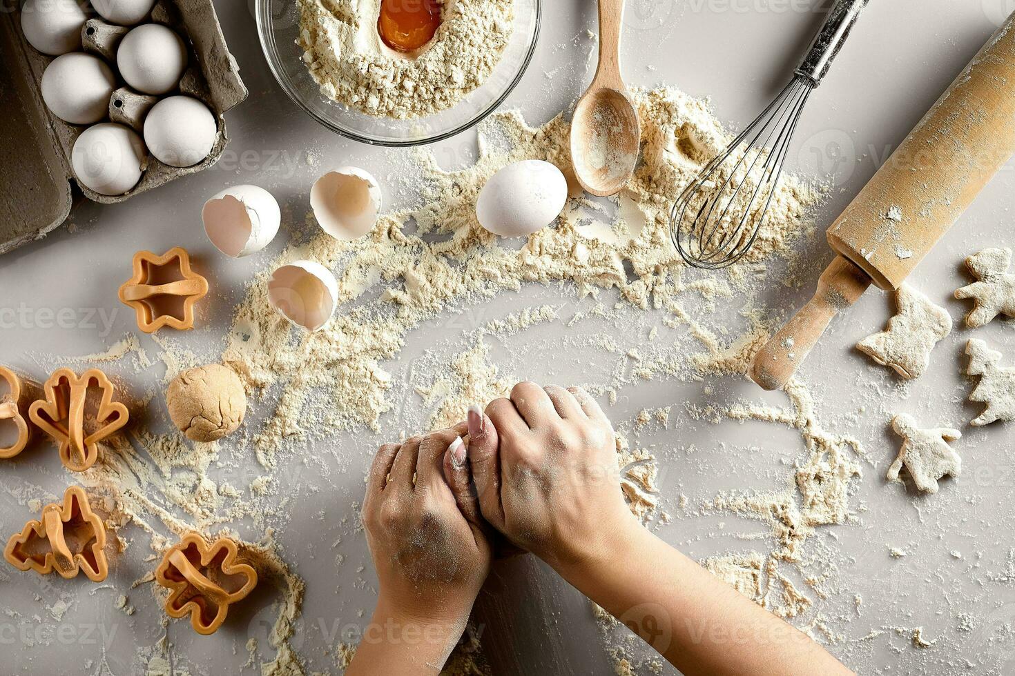 Baking preparation. Raw dough and cutters for the holiday cookies on a white table. Top view. photo