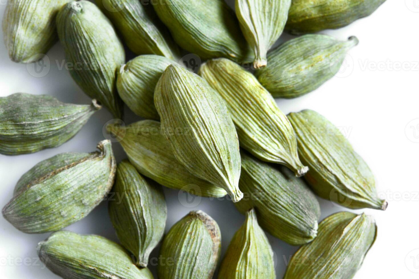 Green cardamom seeds isolated on white background. Top view. Close-up photo