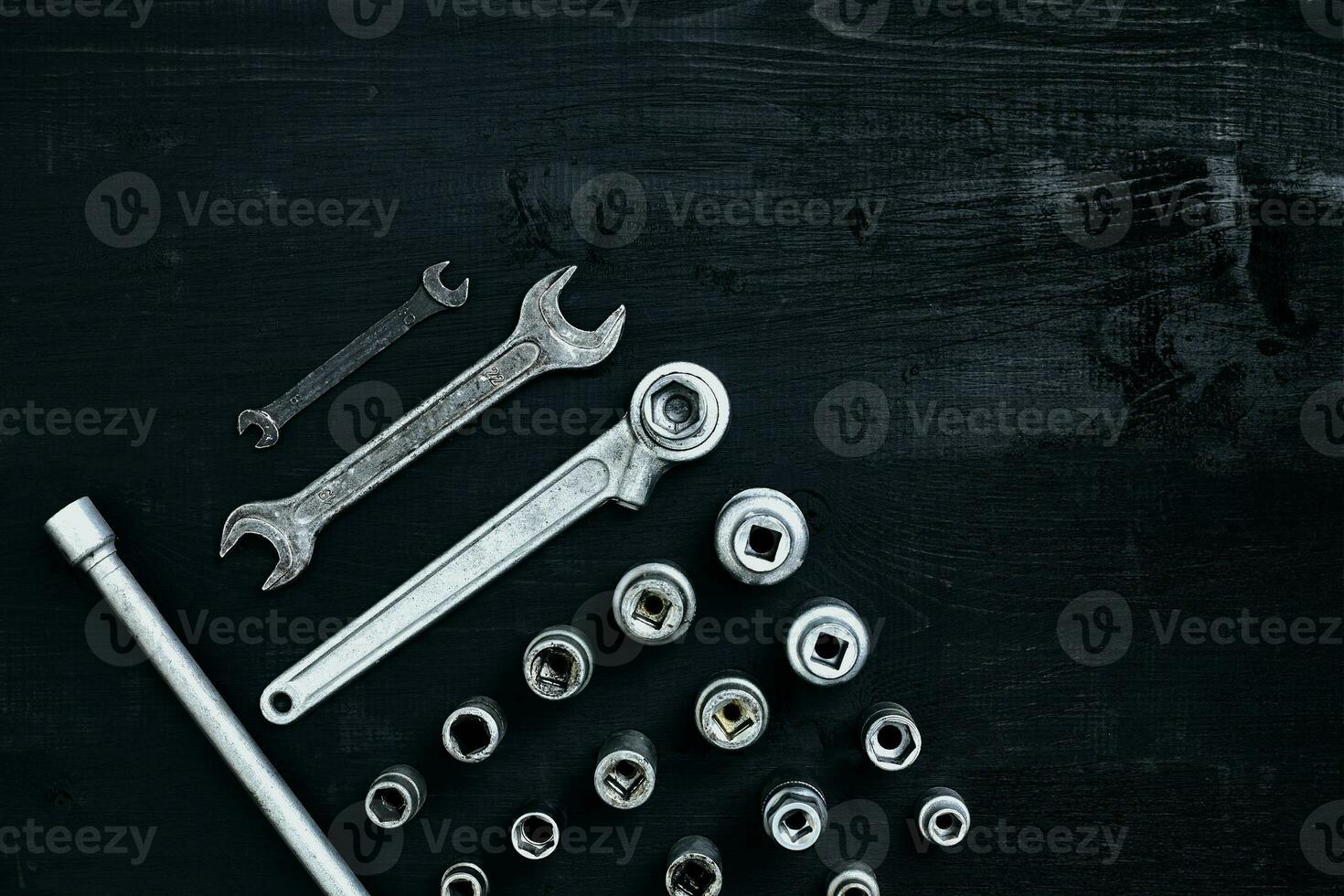 Tools for car repair in Workshop. Car repair equipment on black wooden background in car repair shop photo