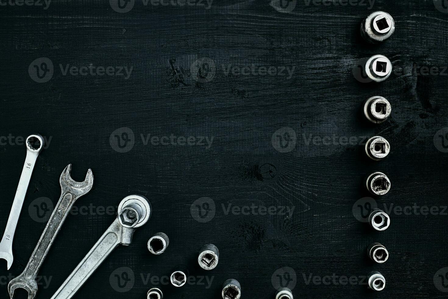 Tools for car repair in Workshop. Car repair equipment on black wooden background in car repair shop photo