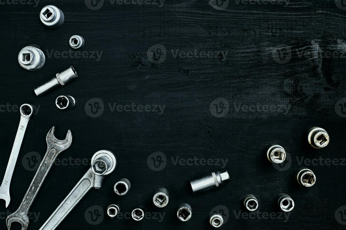 Tools for car repair in Workshop. Car repair equipment on black wooden background in car repair shop photo