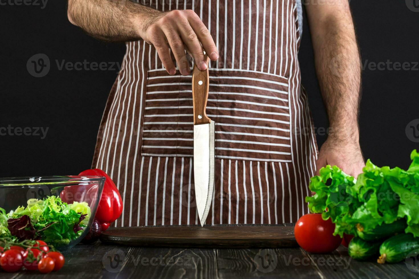 Chef. Professional chef knife including assorted fresh vegetables photo