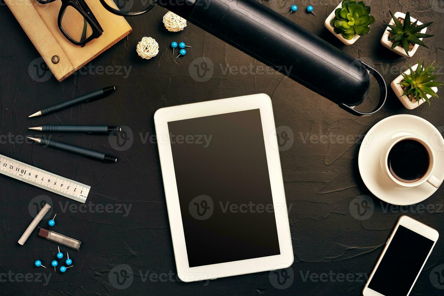 Engineer's desk in office with various gadgets and documents photo
