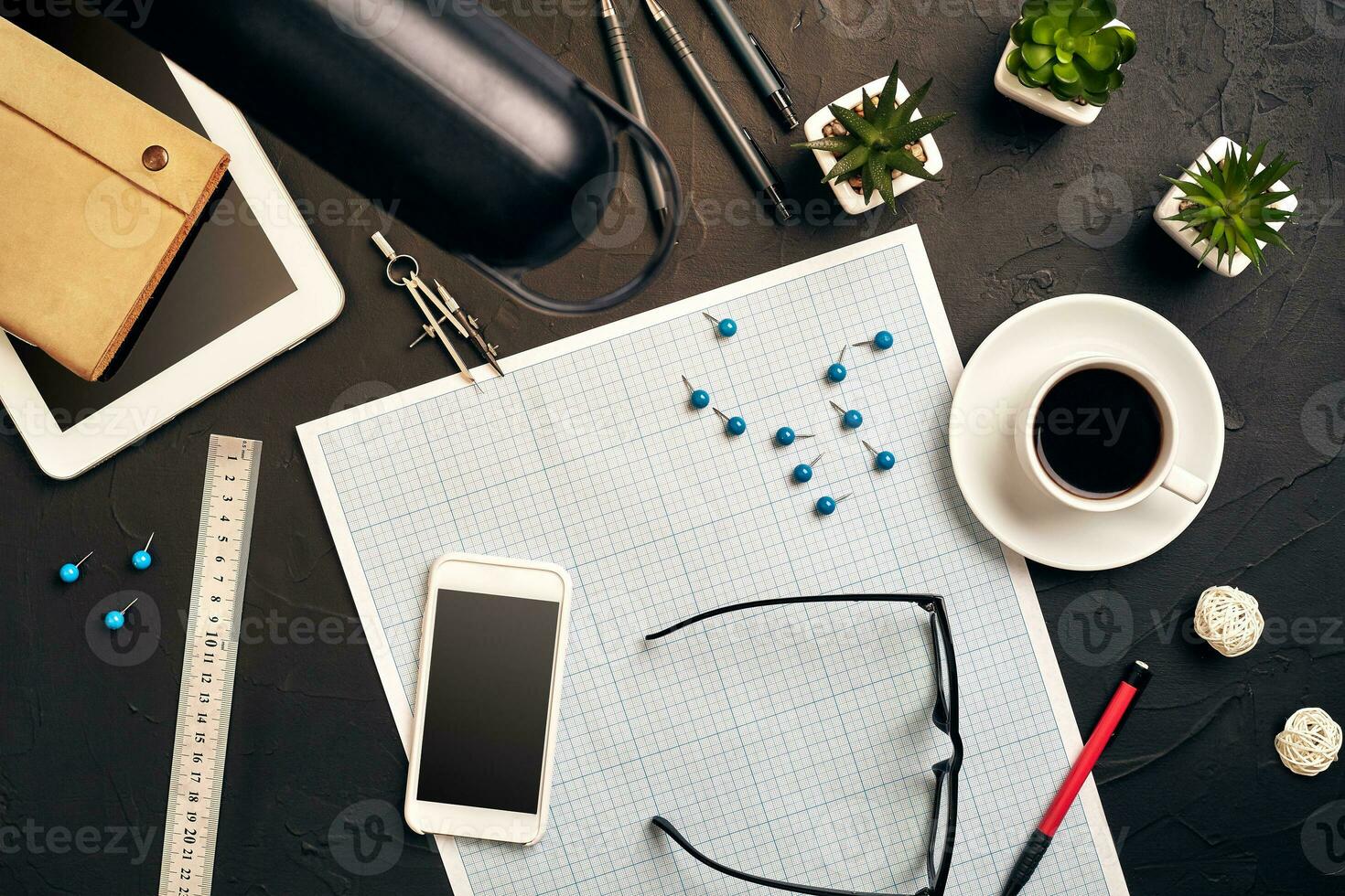 Top view of the builder's workplace, ruler, paper for drawings, compasses, glasses, tablet photo