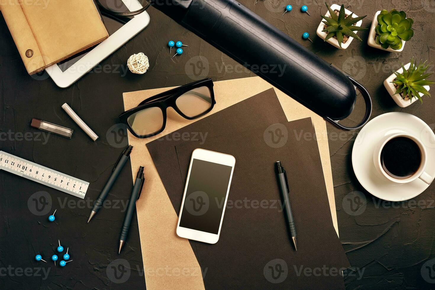 Engineer's desk in office with various gadgets and documents photo