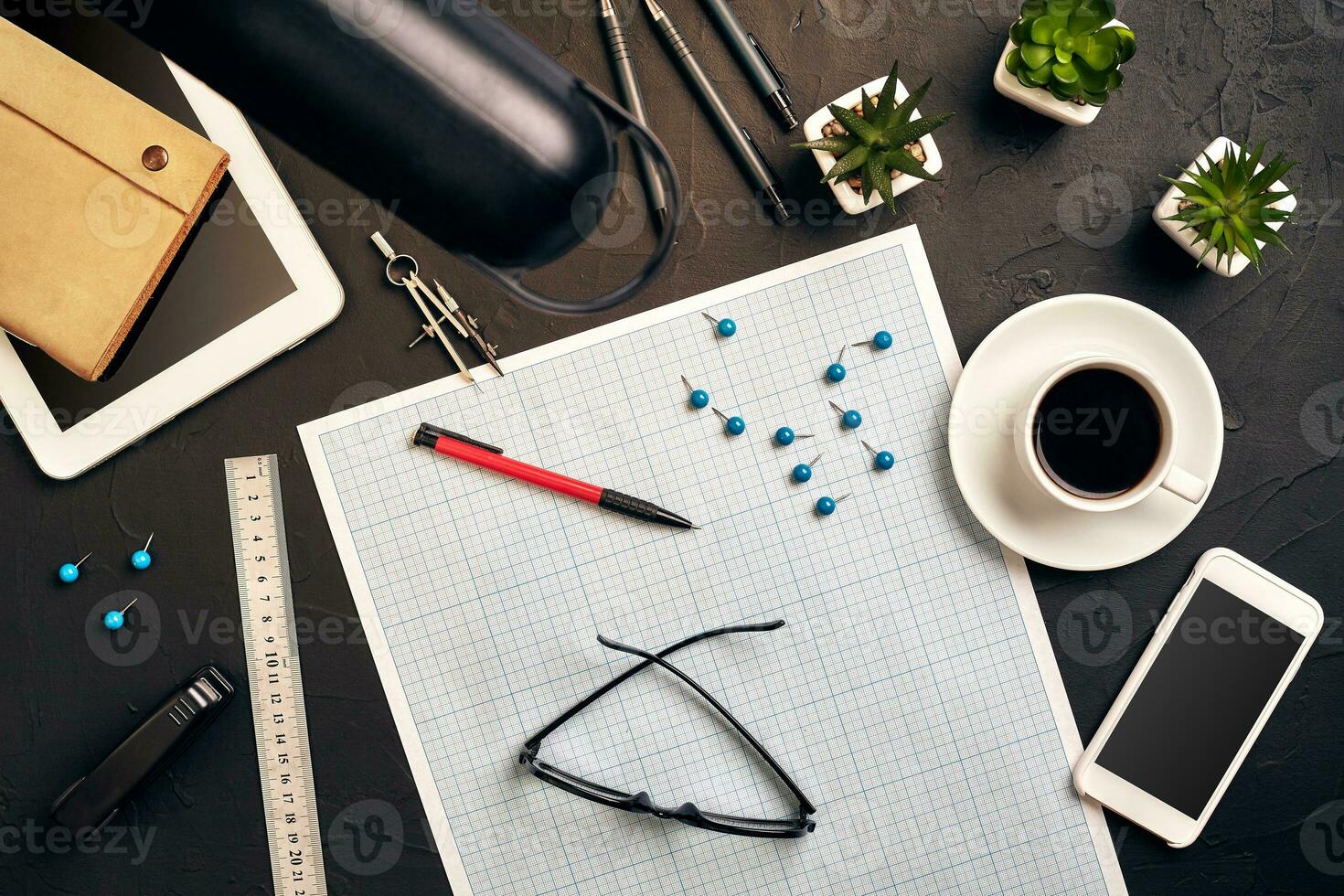 Top view of the builder's workplace, ruler, paper for drawings, compasses, glasses, tablet photo