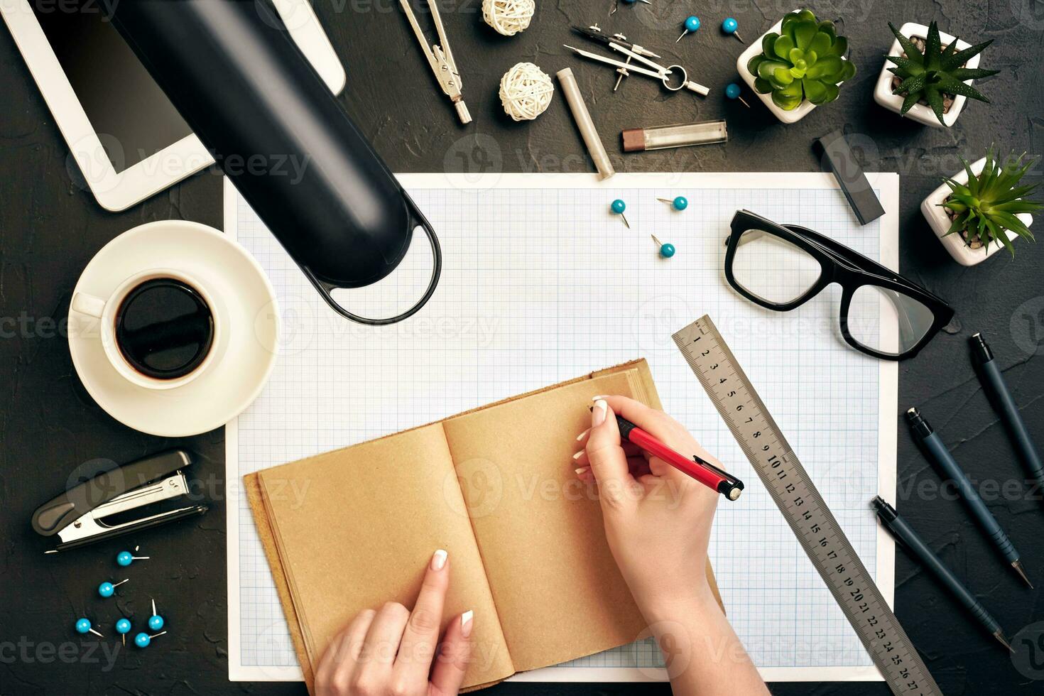 Concept architects. Architects workplace, architectural project, blueprints, ruler. Engineer holds a pen and writes in a notebook. Equipment architects on the desk with a blueprint in the office. photo