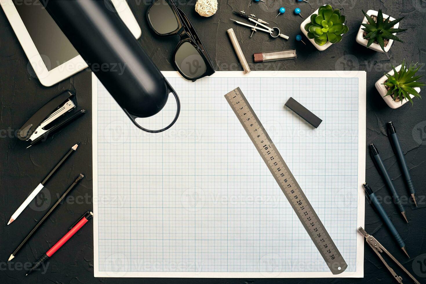 Top view of the builder's workplace, ruler, paper for drawings, compasses, glasses, tablet photo