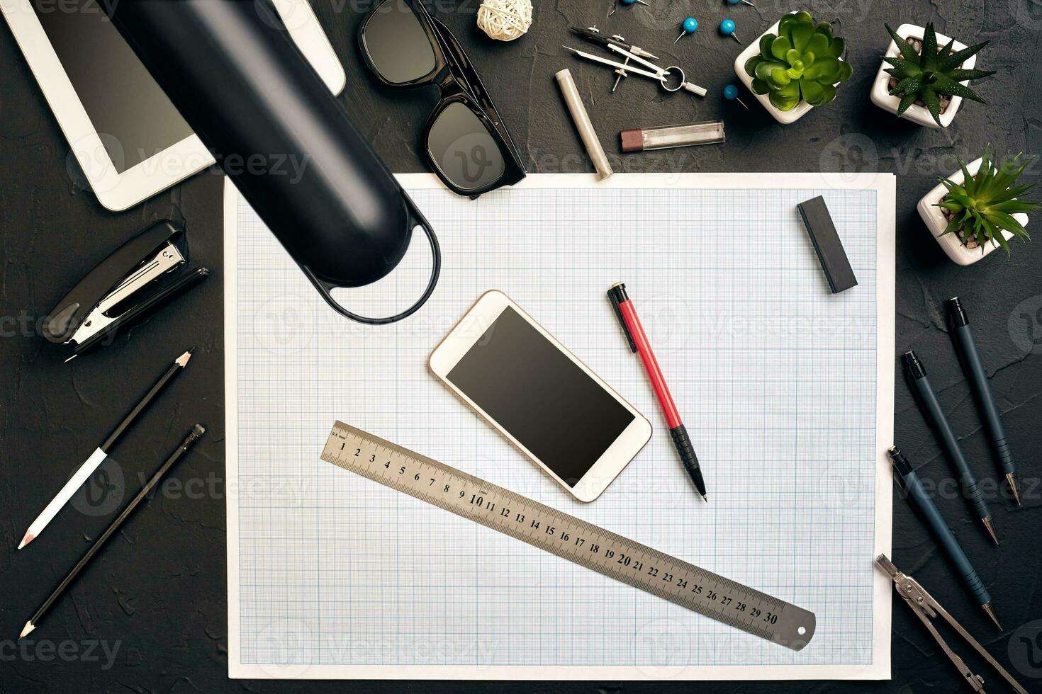 Top view of the builder's workplace, ruler, paper for drawings, compasses, glasses, tablet photo