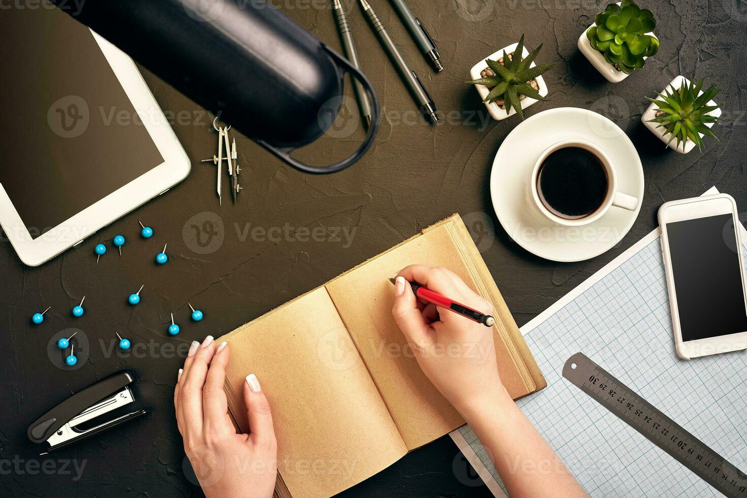 Concept architects. Architects workplace, architectural project, blueprints, ruler. Engineer holds a pen and writes in a notebook. Equipment architects on the desk with a blueprint in the office. photo