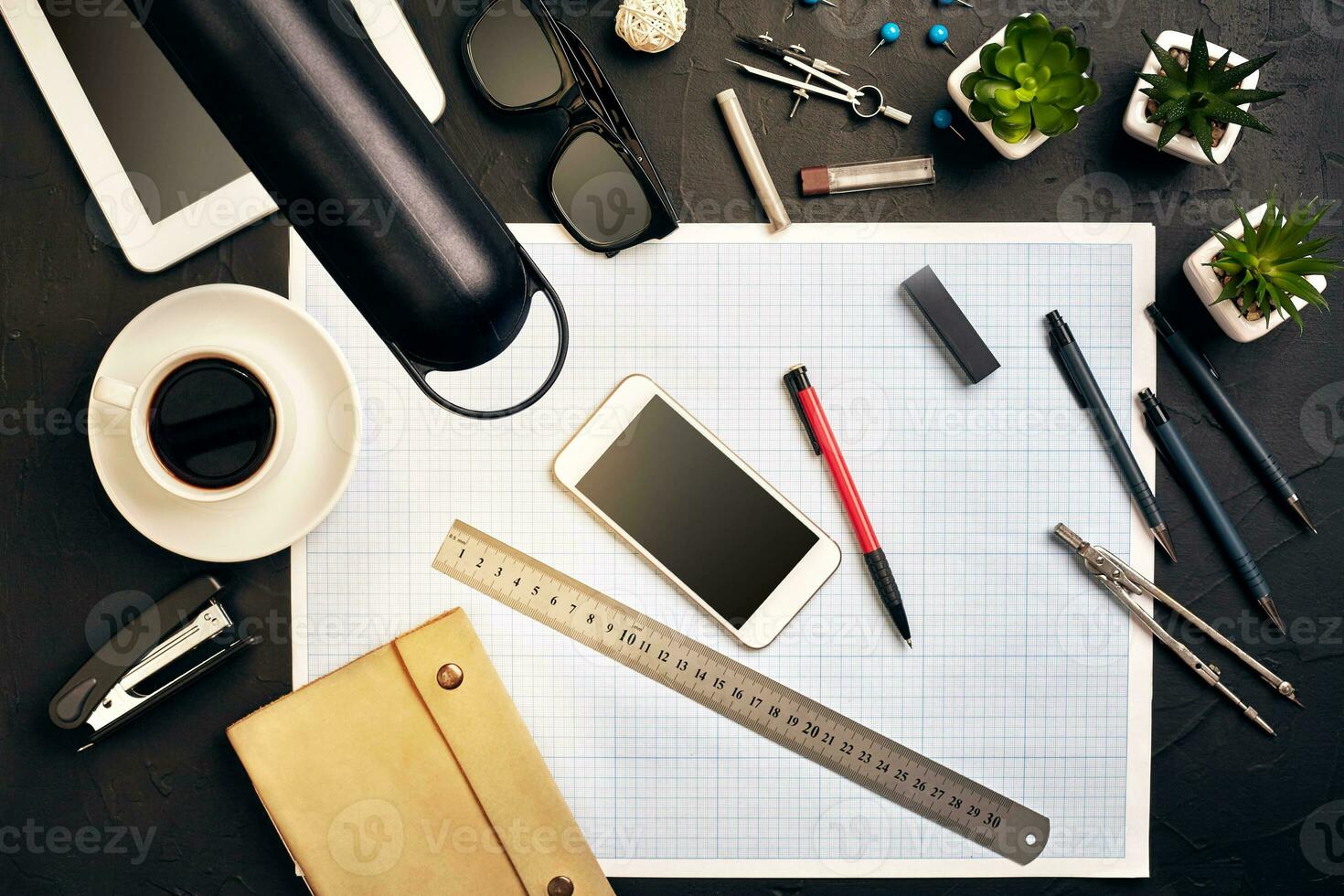 Top view of the builder's workplace, ruler, paper for drawings, compasses, glasses, tablet photo