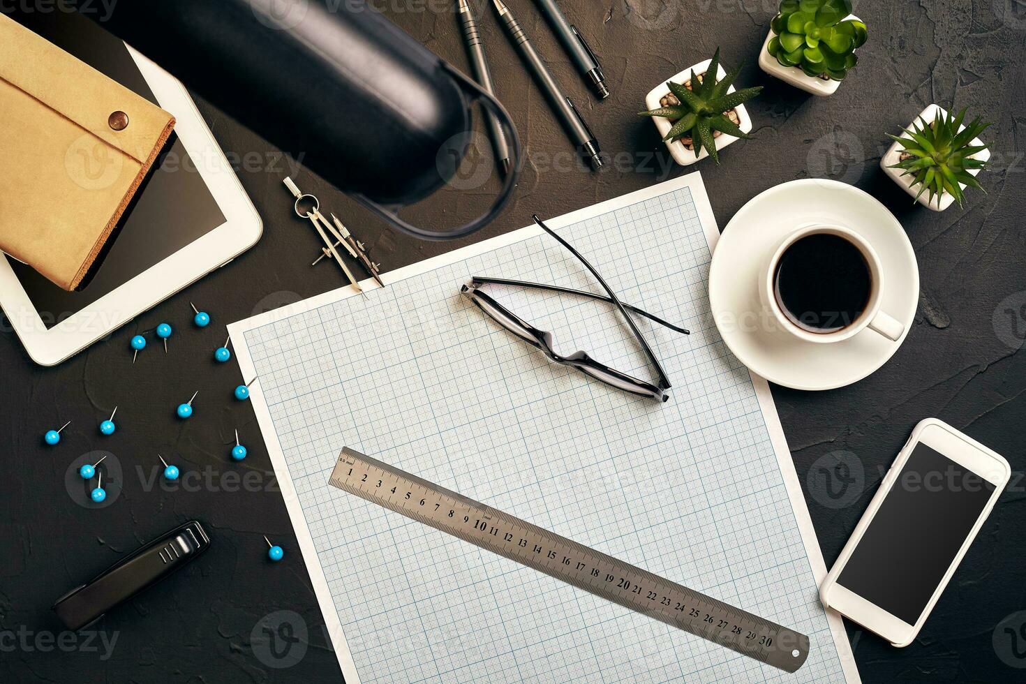 Top view of the builder's workplace, ruler, paper for drawings, compasses, glasses, tablet photo