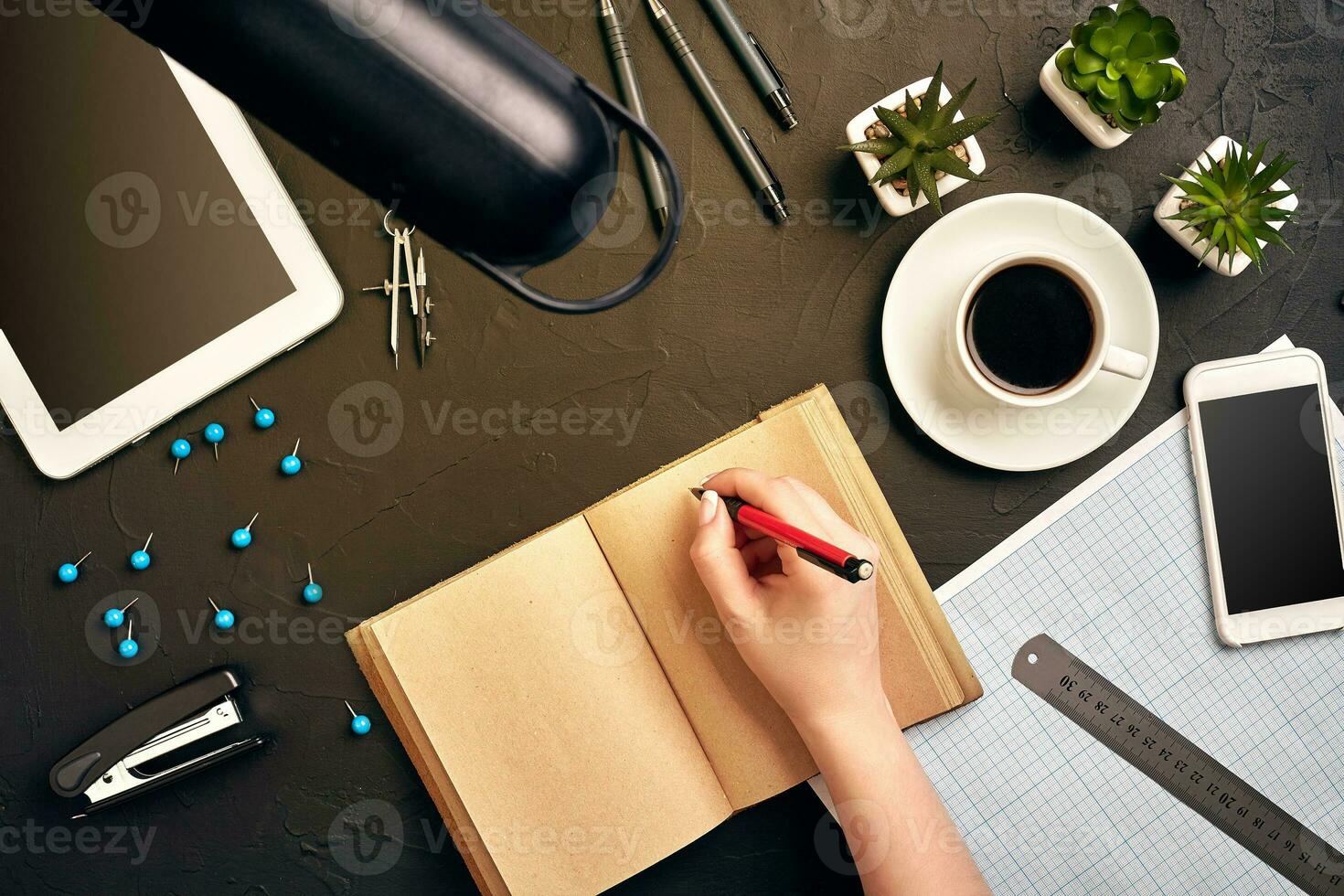 Concept architects. Architects workplace, architectural project, blueprints, ruler. Engineer holds a pen and writes in a notebook. Equipment architects on the desk with a blueprint in the office. photo