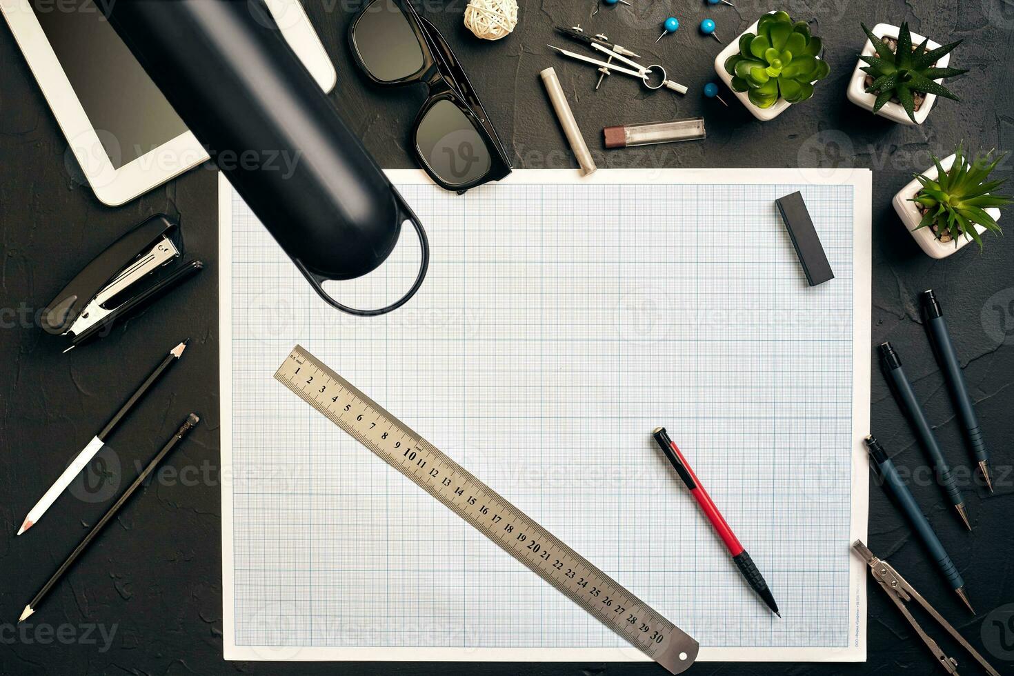 Top view of the builder's workplace, ruler, paper for drawings, compasses, glasses, tablet photo