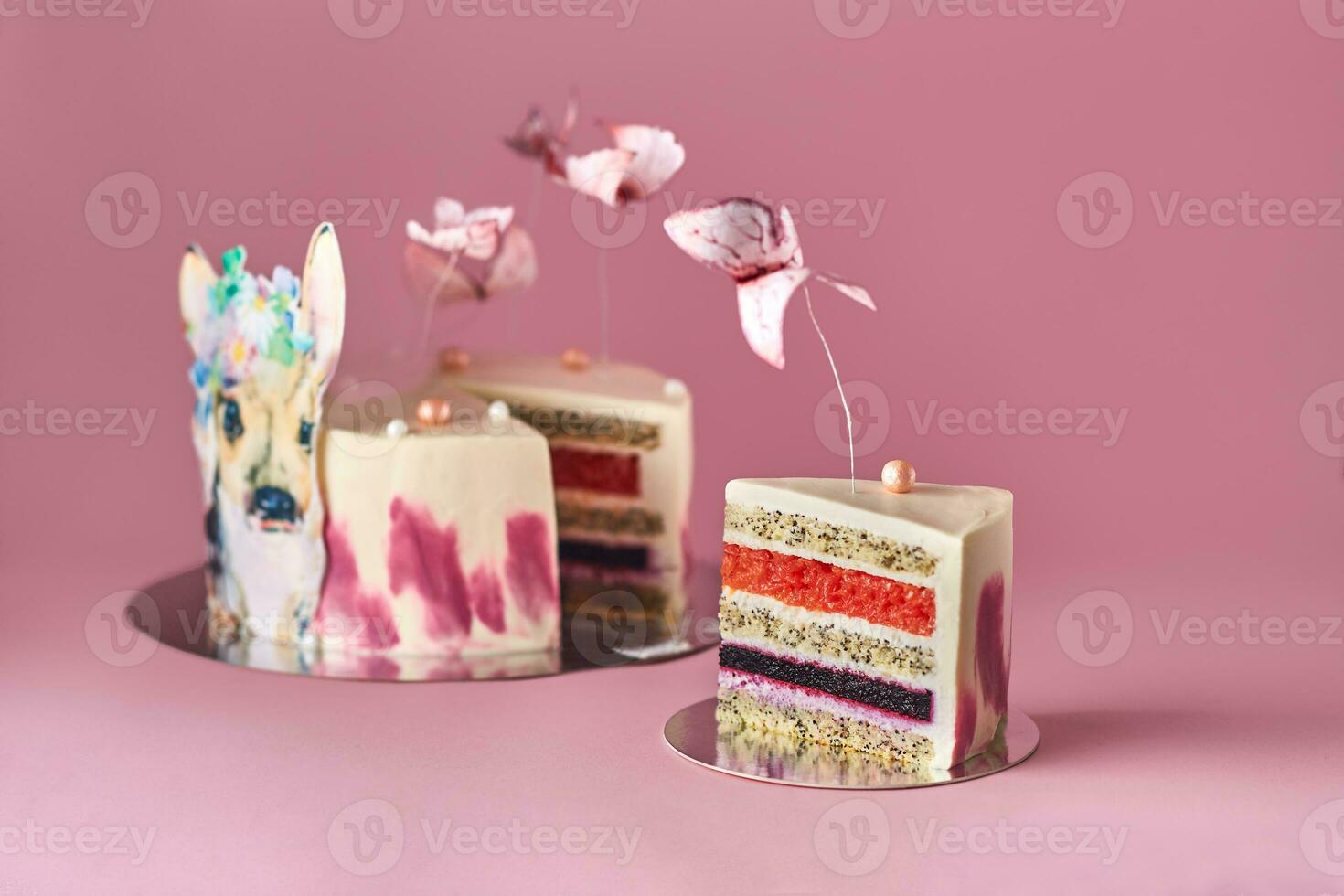 Pastel colors tasty cake with butterflies and little deer. Pink background. Selective focus. photo