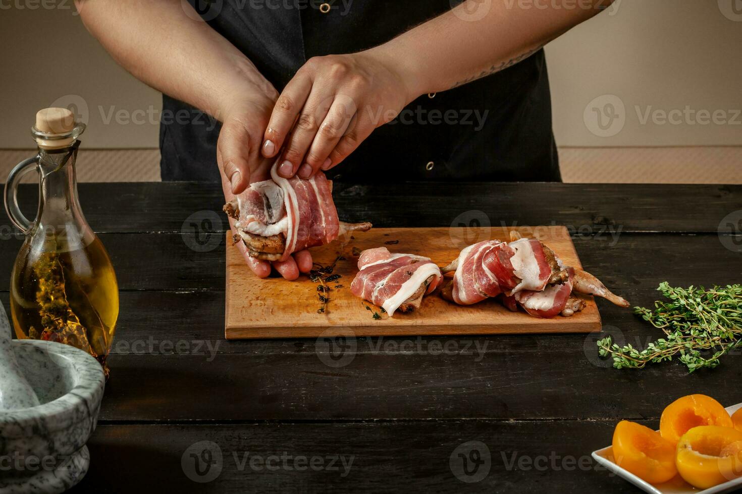 Preparing quail specialty, rolling quail with bacon photo