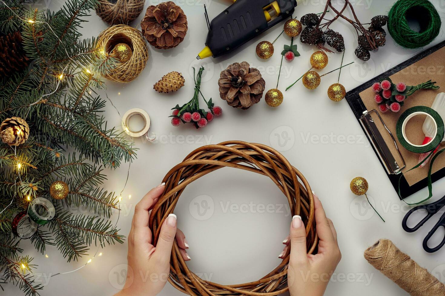 Christmas background with decorations, garland and pine cones. Creating wreath made of christmas tree branches on white background. photo