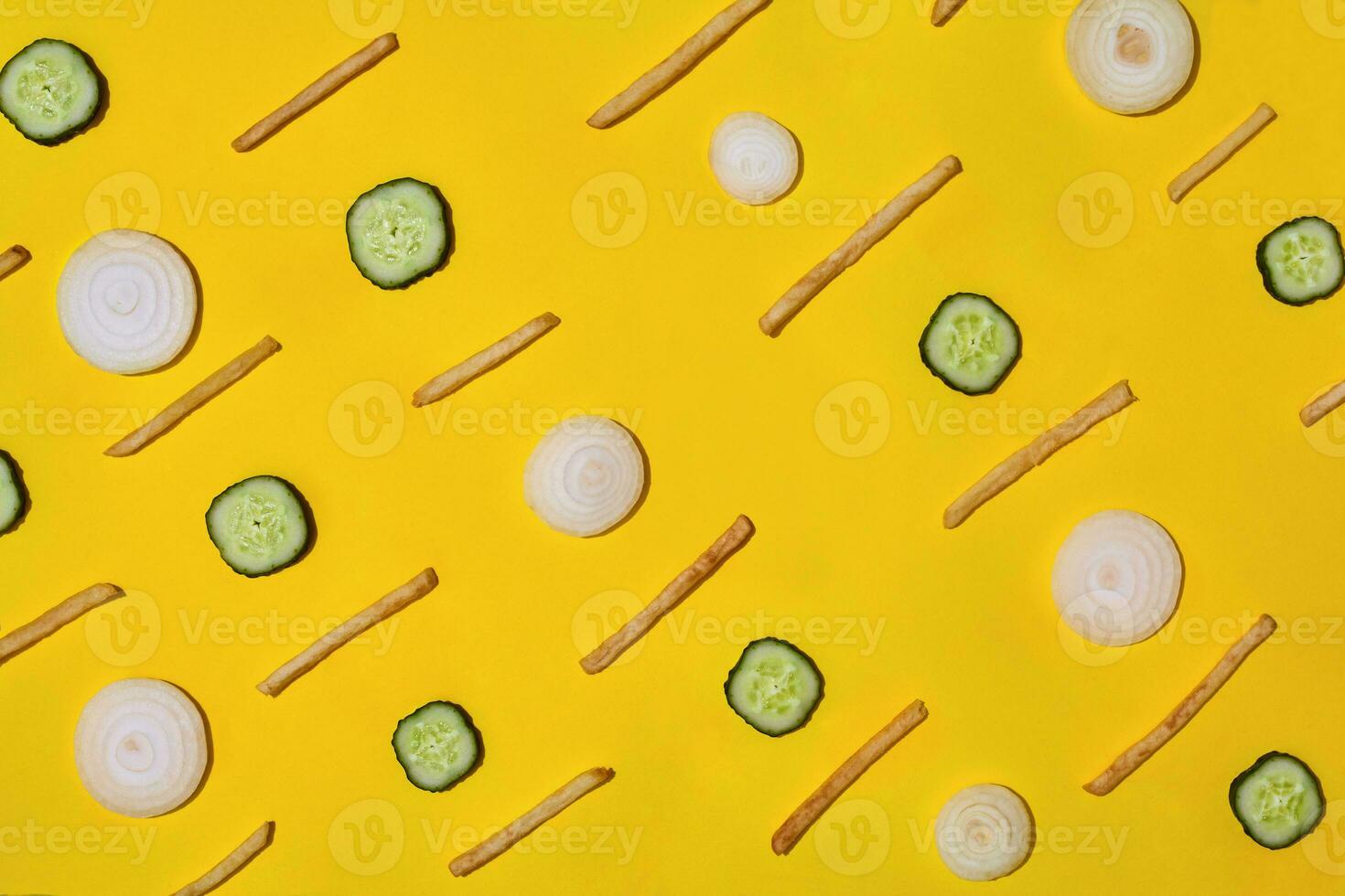 Heap of french fries on yellow background, top view photo