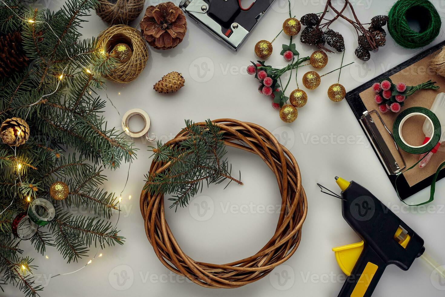 Christmas background with decorations, garland and pine cones. Creating wreath made of christmas tree branches on white background. photo