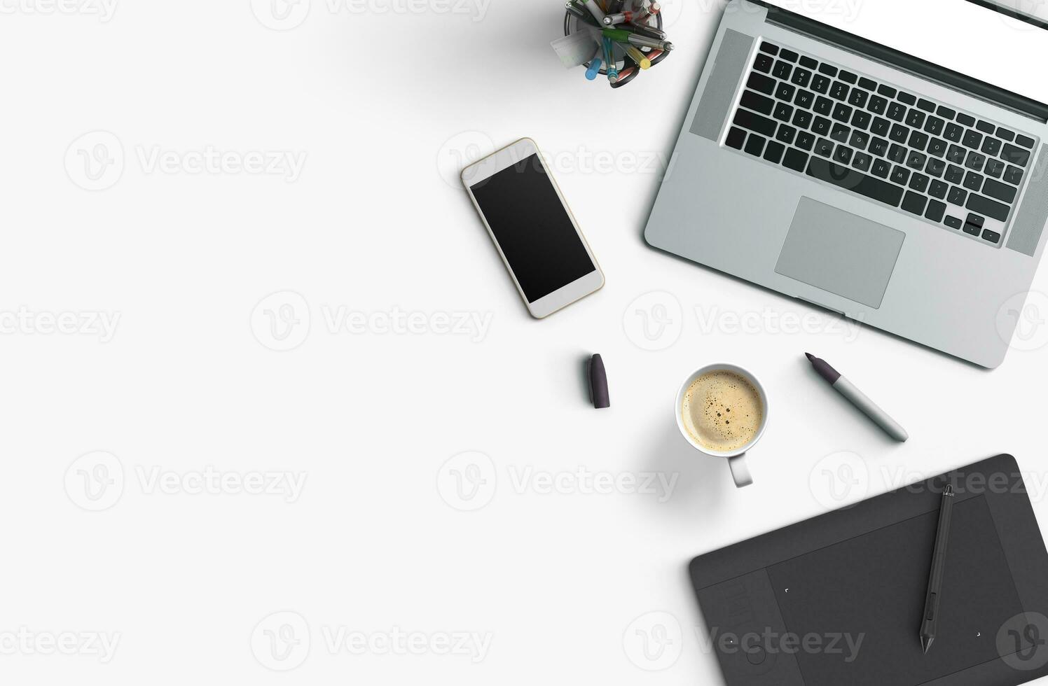 Office desk table with laptop computer, smartphone with black screen over a notebook and cup of coffee. Top view. photo