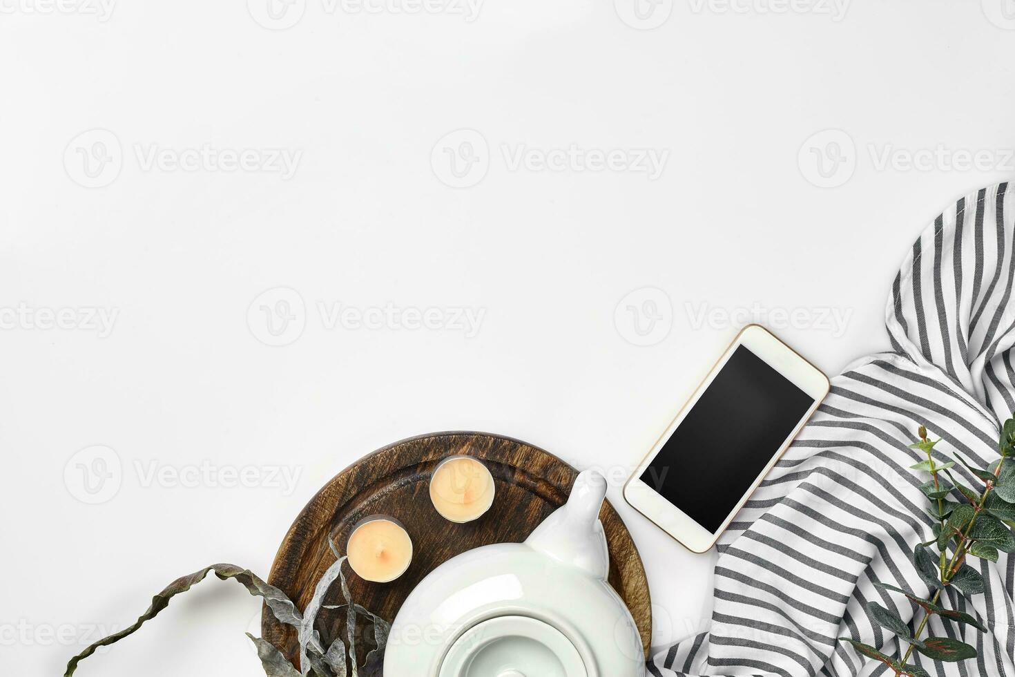 Still life with tea cup and the contents of a workspace composed. Different objects on white table. Flat lay photo