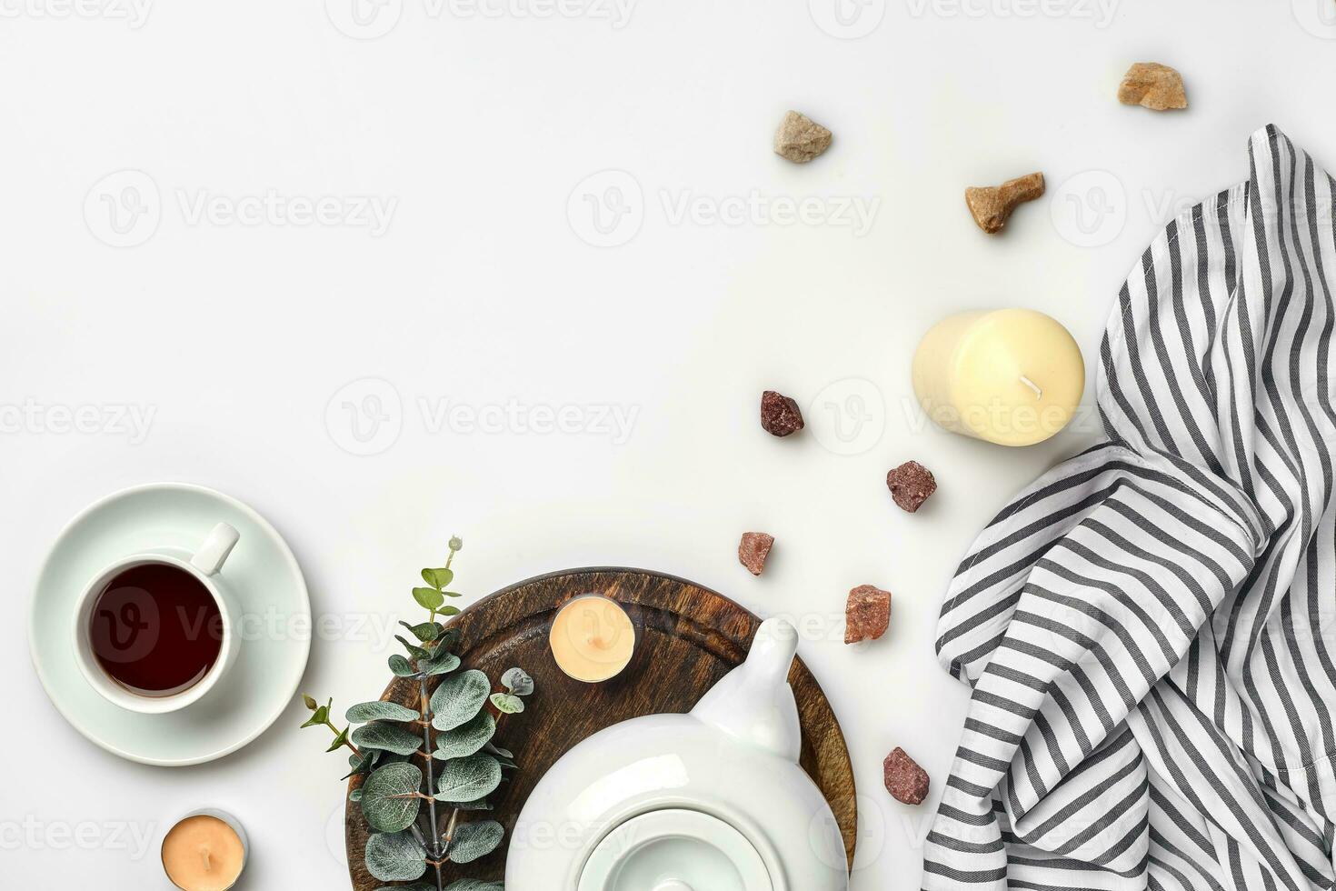 Still life with tea cup and the contents of a workspace composed. Different objects on white table. Flat lay photo