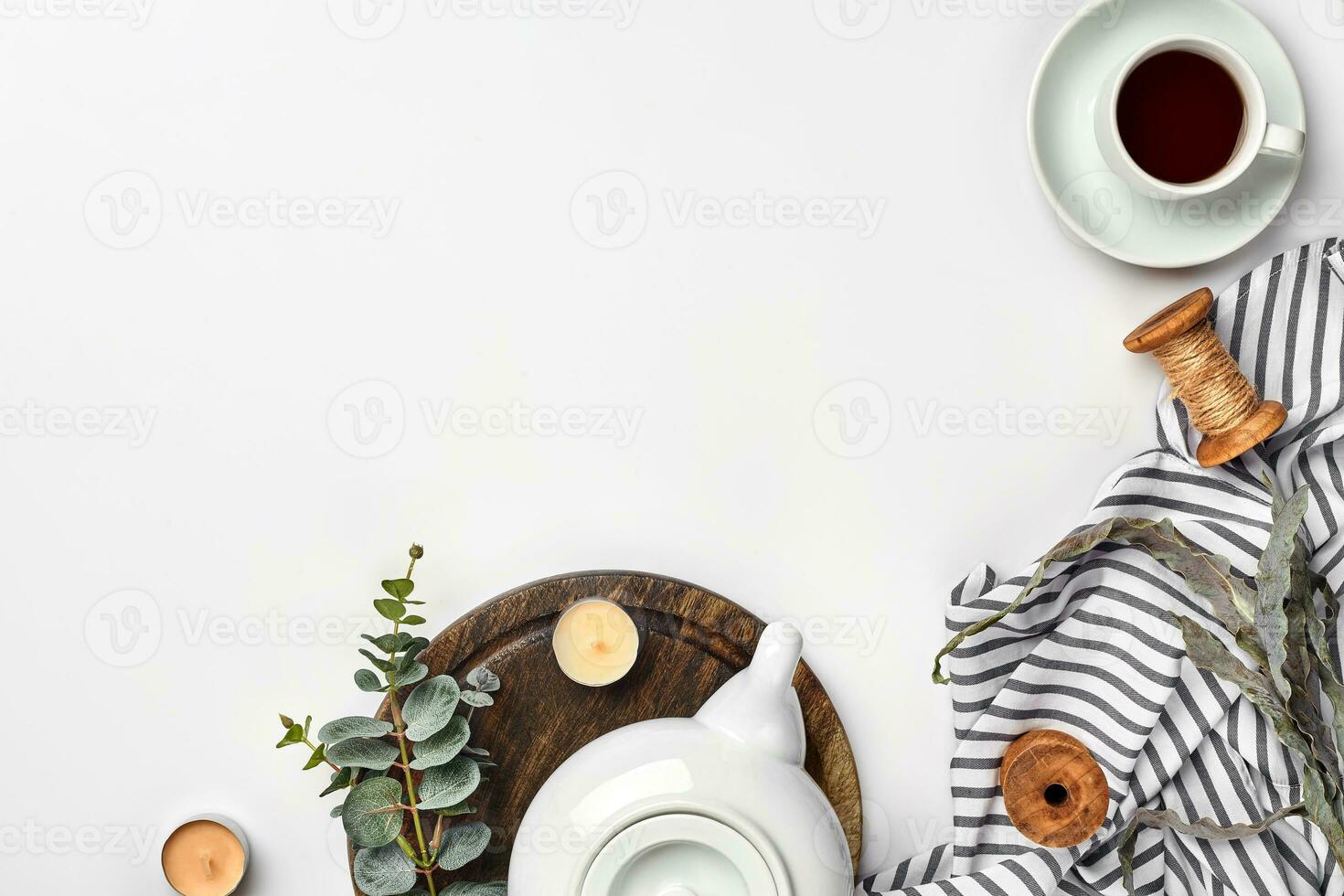 Still life with tea cup and the contents of a workspace composed. Different objects on white table. Flat lay photo