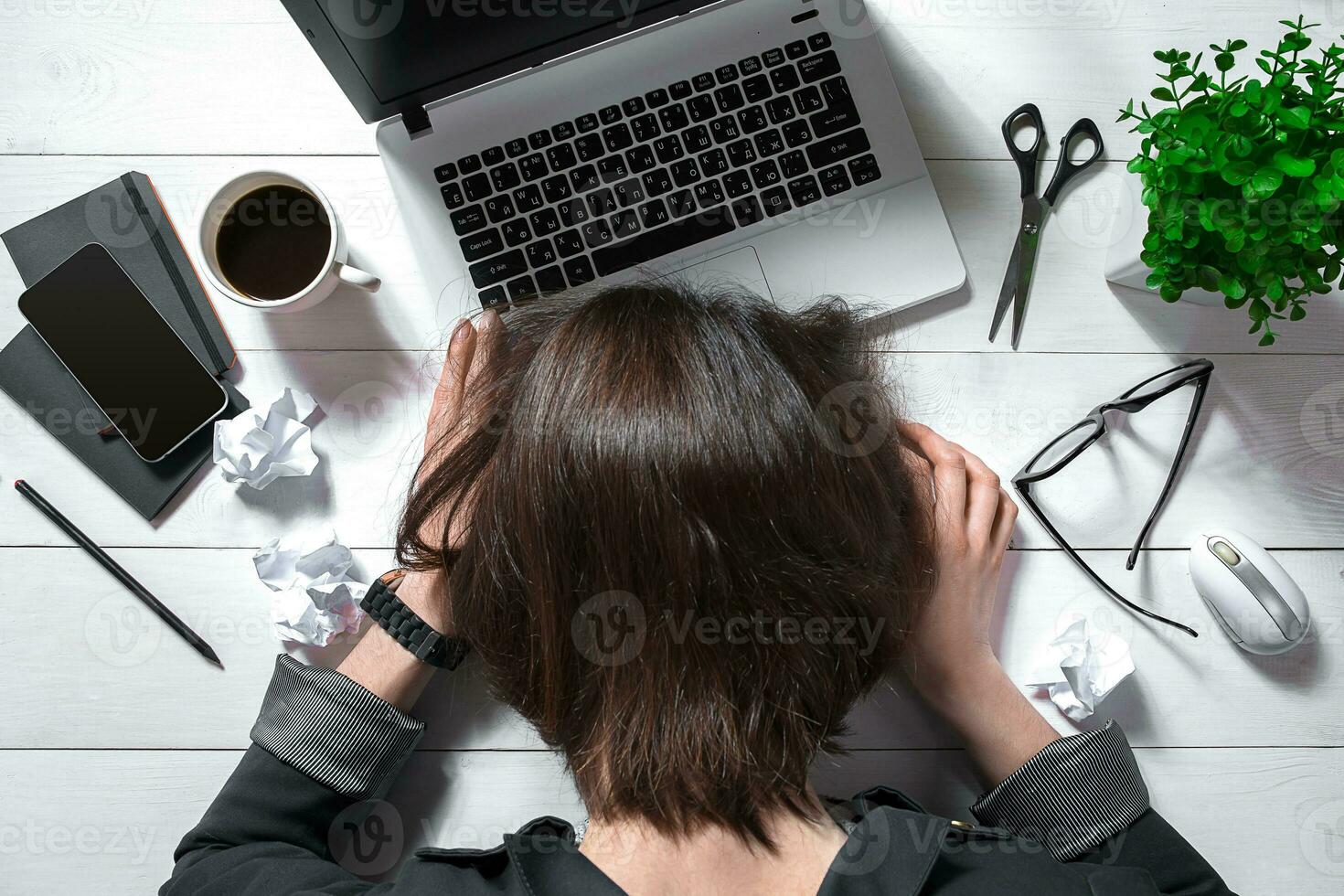 Overhead view of businesswoman working at computer in office photo