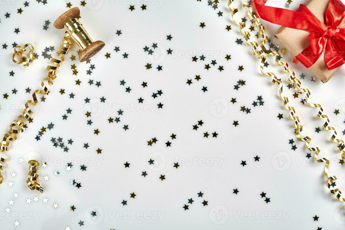 Delicate wavy ribbons and metallic star shaped confetti isolated on white background. Christmas holidays decoration concept. photo