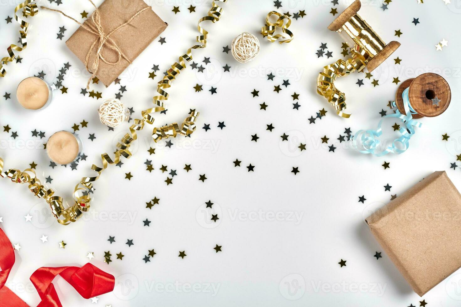 Delicate wavy ribbons and metallic star shaped confetti isolated on white background. Christmas holidays decoration concept. photo