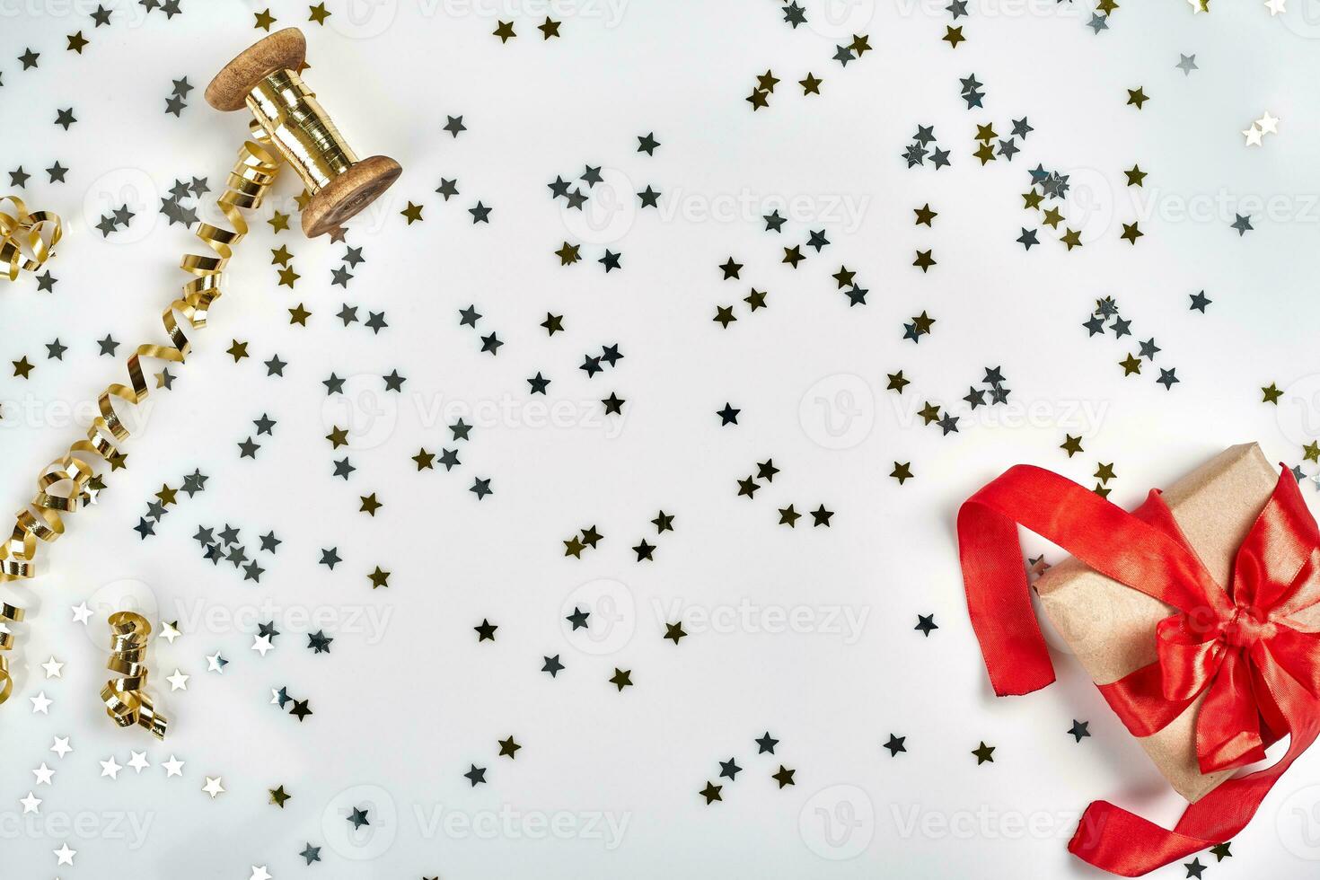 Delicate wavy ribbons and metallic star shaped confetti isolated on white background. Christmas holidays decoration concept. photo