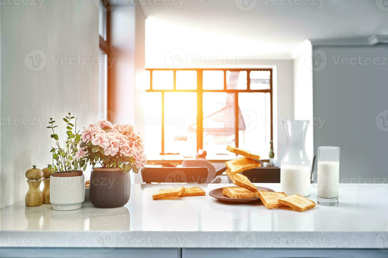 Served table for breakfast with toast, milk and honey, on blurred background. Sun flare photo