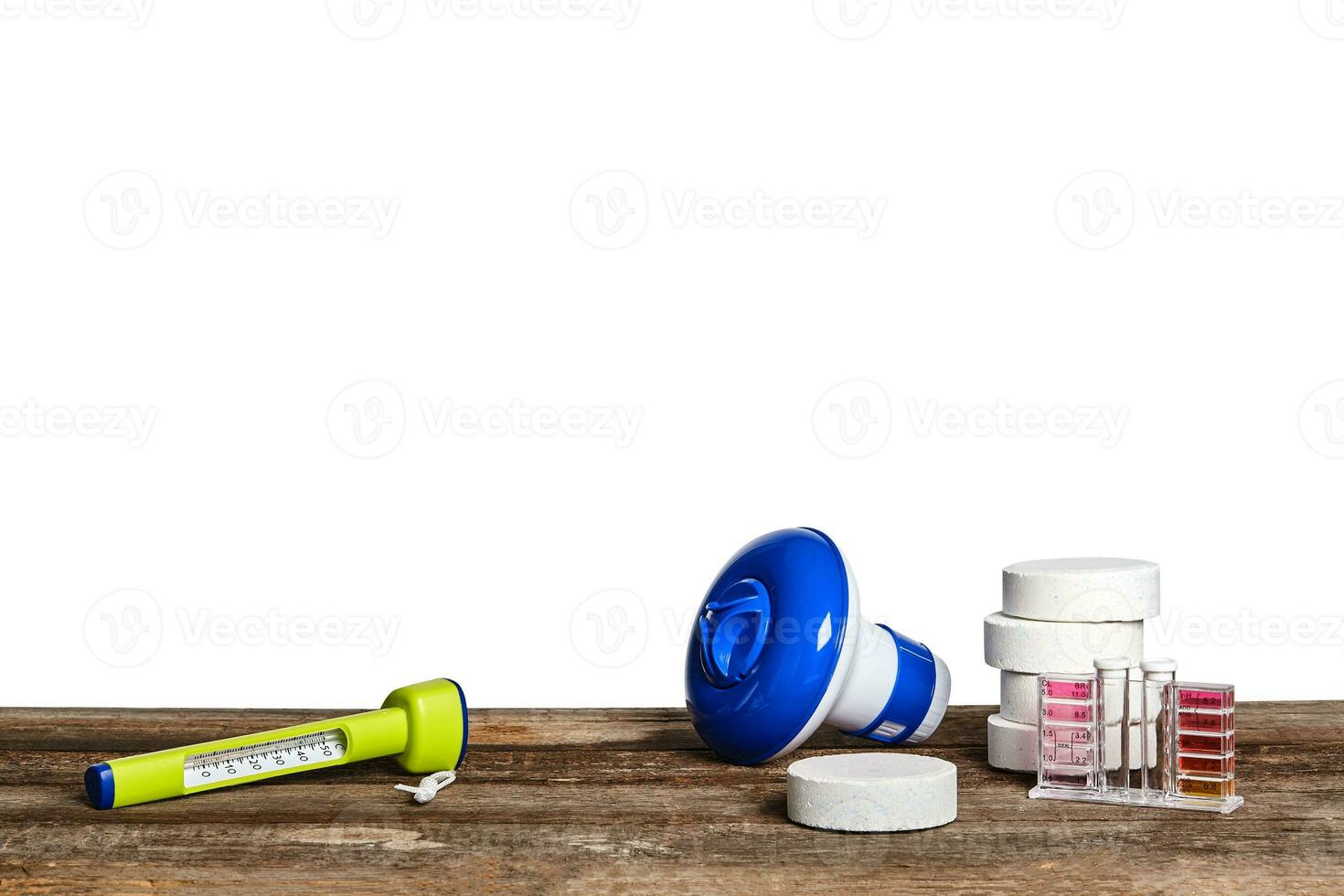 Equipment with chemical cleaning products and tools for the maintenance of the swimming pool on a wooden surface against white background. photo